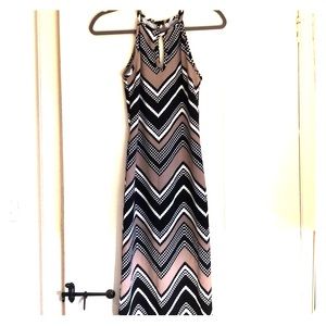 Midi length body-con dress. Sleeveless, high neck
